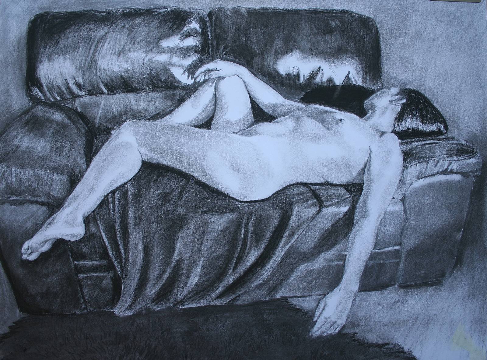 Reclining nude on leather sofa. 